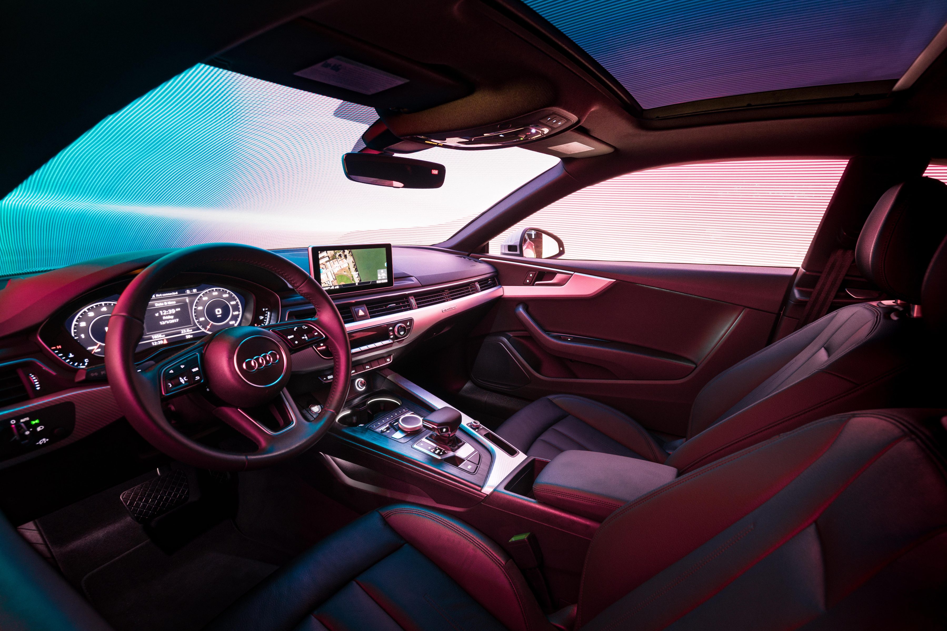 Futuristic Audi car interior with digital dashboard, touchscreen, and colored ambient lighting—perfect for a photographer capturing cutting-edge design or showcasing mesmerizing drone light painting effects.