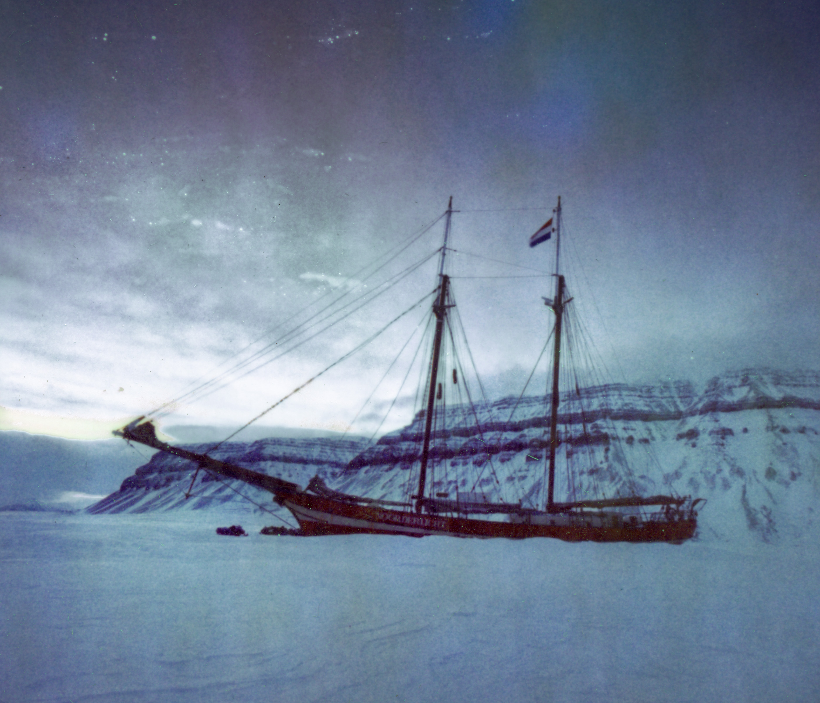 A tall ship frozen in ice with snowy mountains in the background under a dusky sky, captured through the lens of a fine artist.