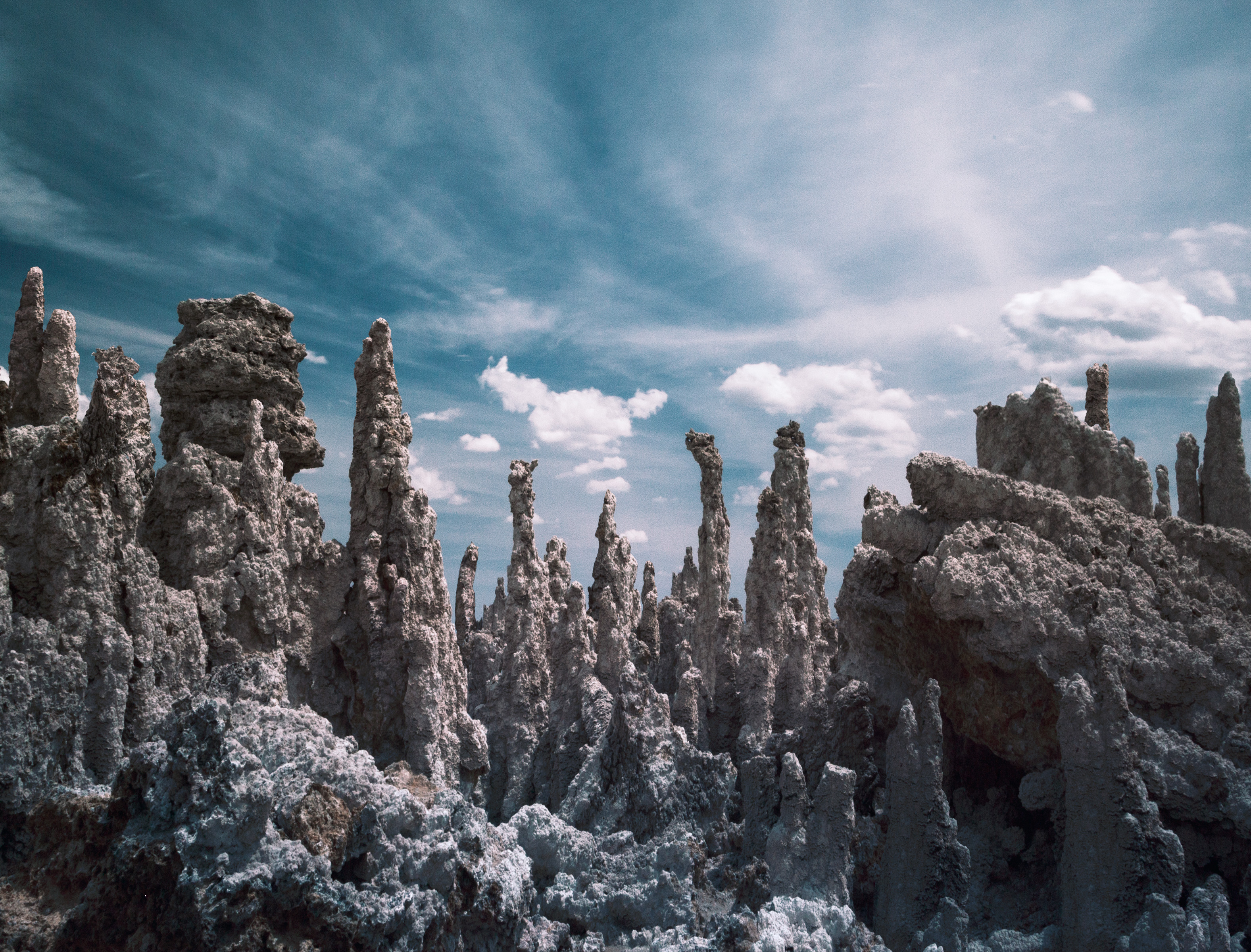 Jagged limestone formations rise under a blue sky with scattered clouds, inviting any photographer to capture their beauty.