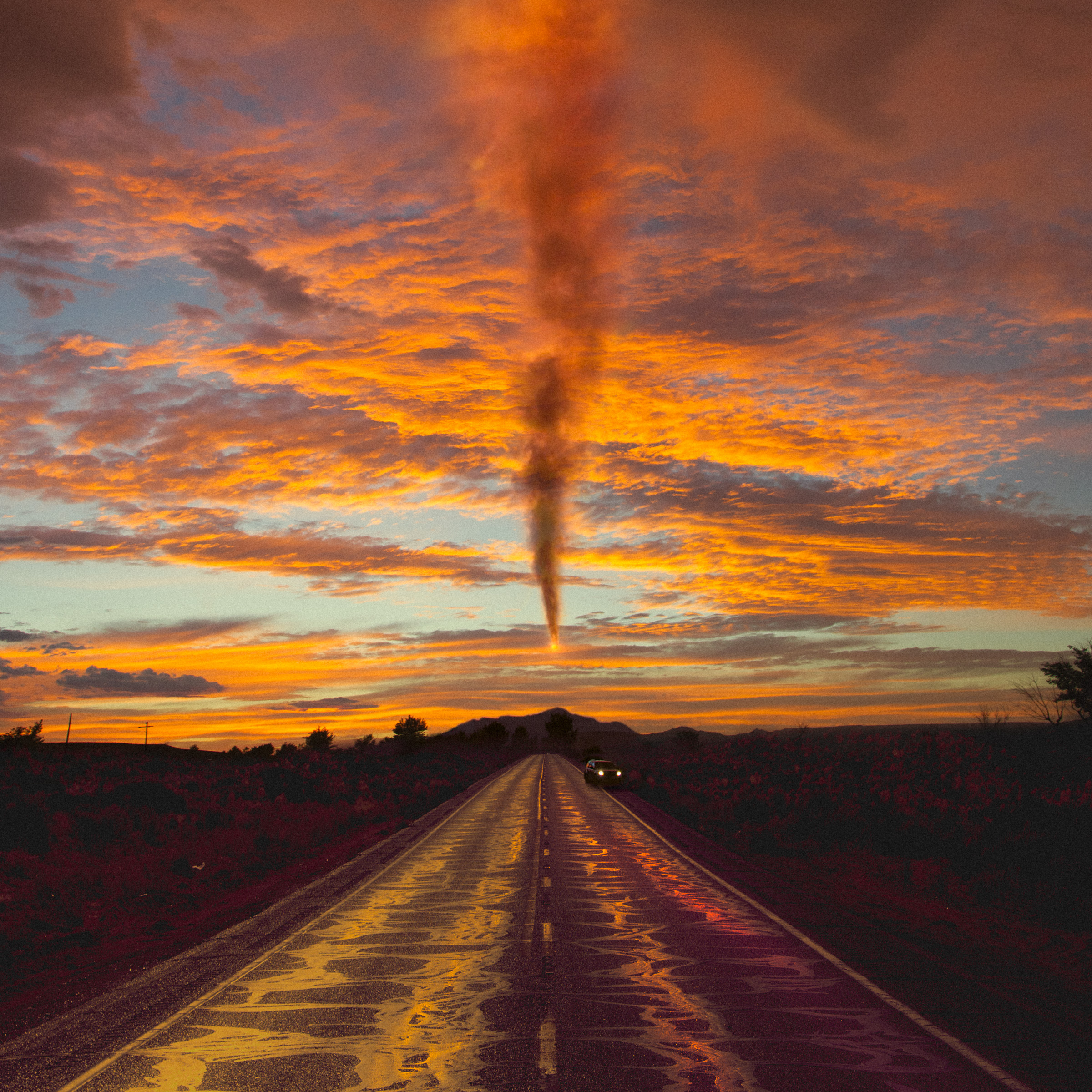 A dramatic sunset sky with a funnel cloud over a wet road, reflecting orange and yellow hues, evokes the vision of a fine artist capturing futuristic beauty.