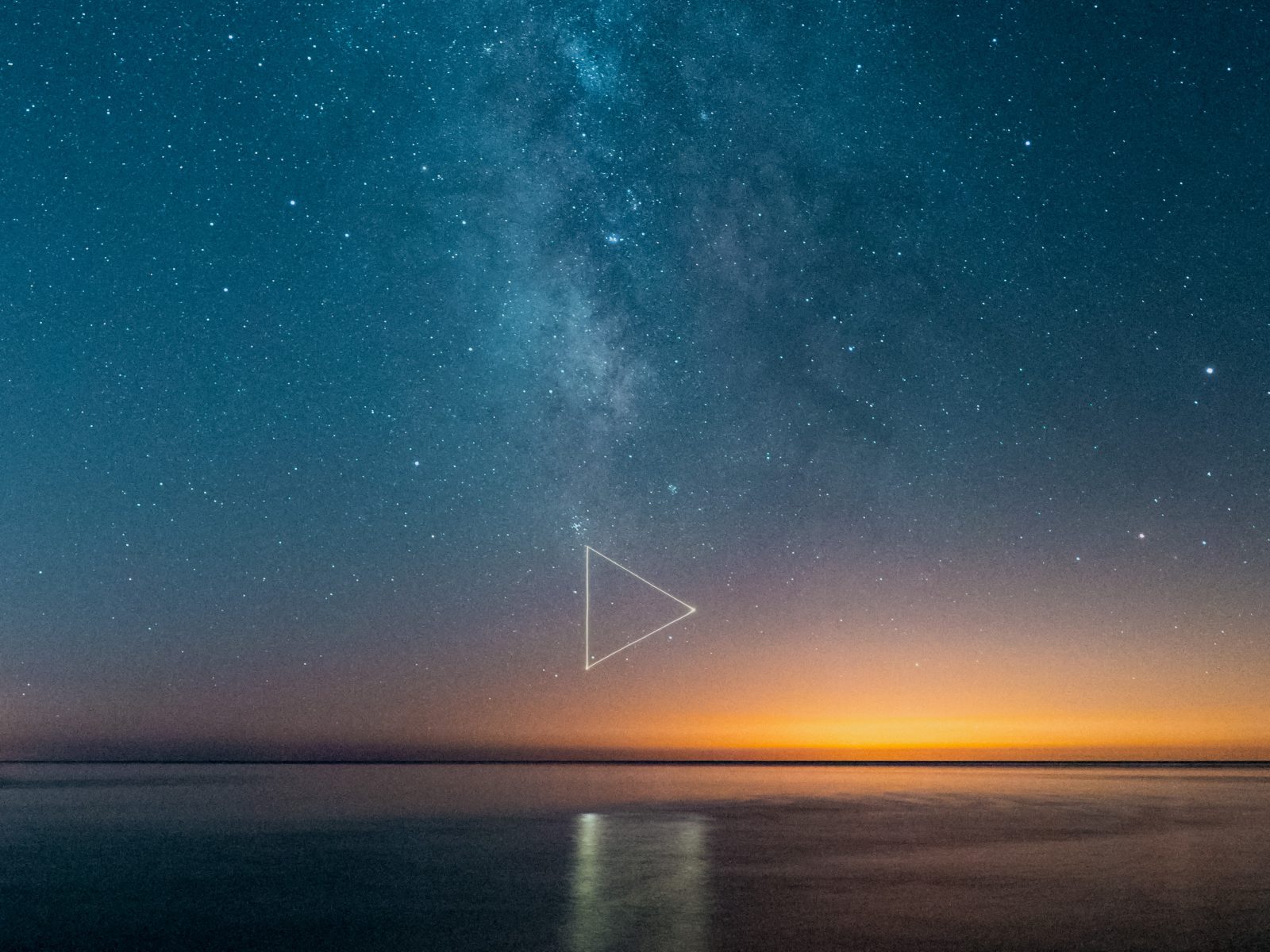 Milky Way and stars over calm water at sunset, captured in a nighttime landscape photography style, with a faint triangle symbol glowing in the sky.