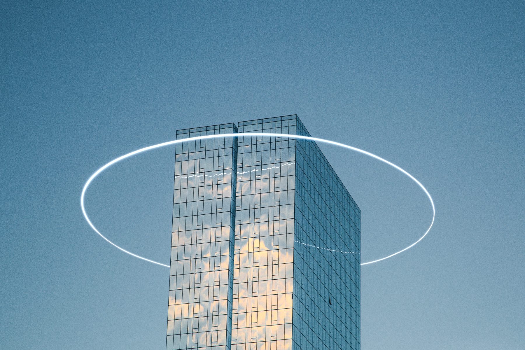 A glass skyscraper reflects clouds beneath a clear sky, while a futuristic white glowing ring—reminiscent of drone light art—encircles the building.