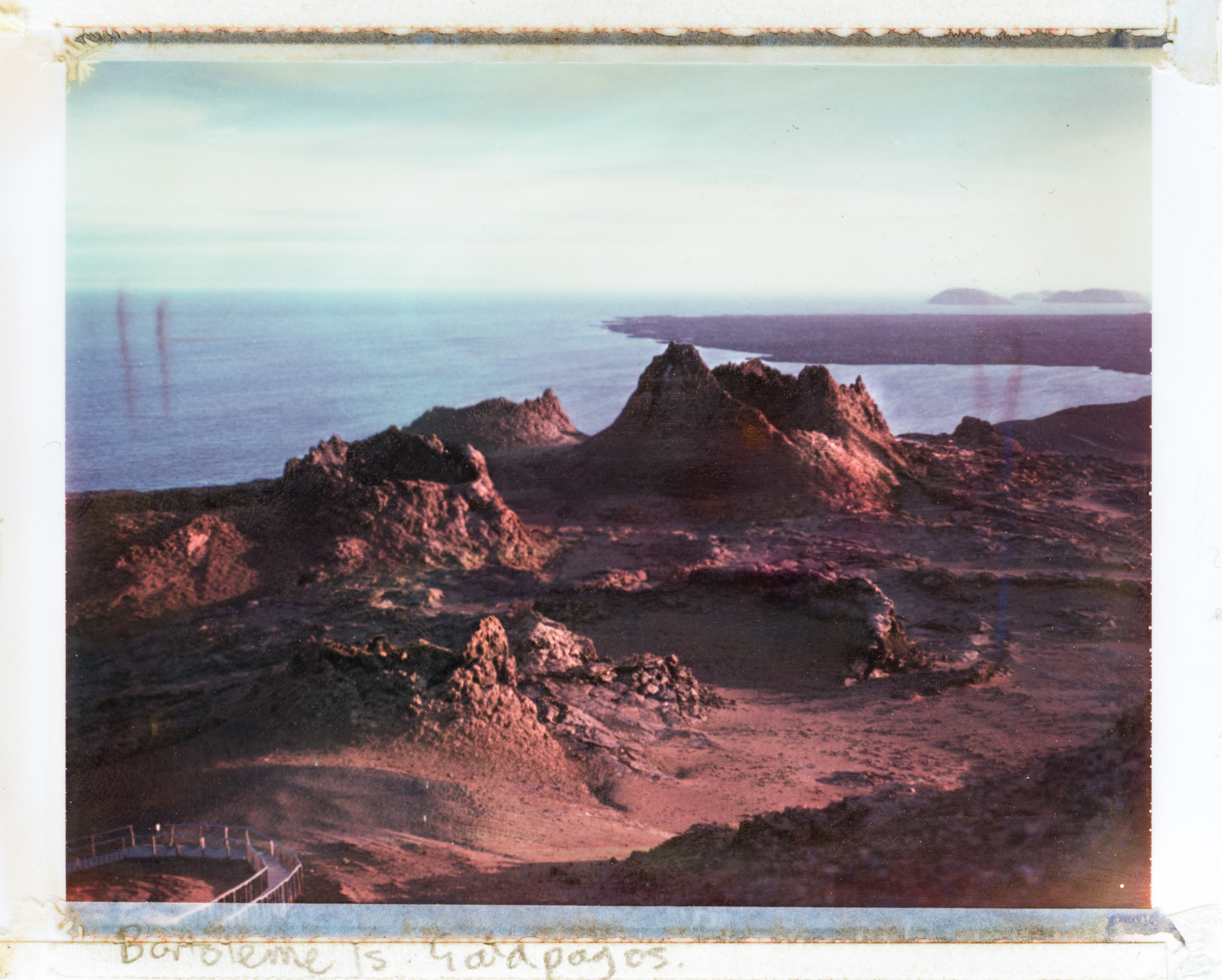 Rocky volcanic landscape by the ocean at sunset, with rugged hills and a distant shoreline, transformed by futuristic drone light painting in this stunning nighttime landscape photography.