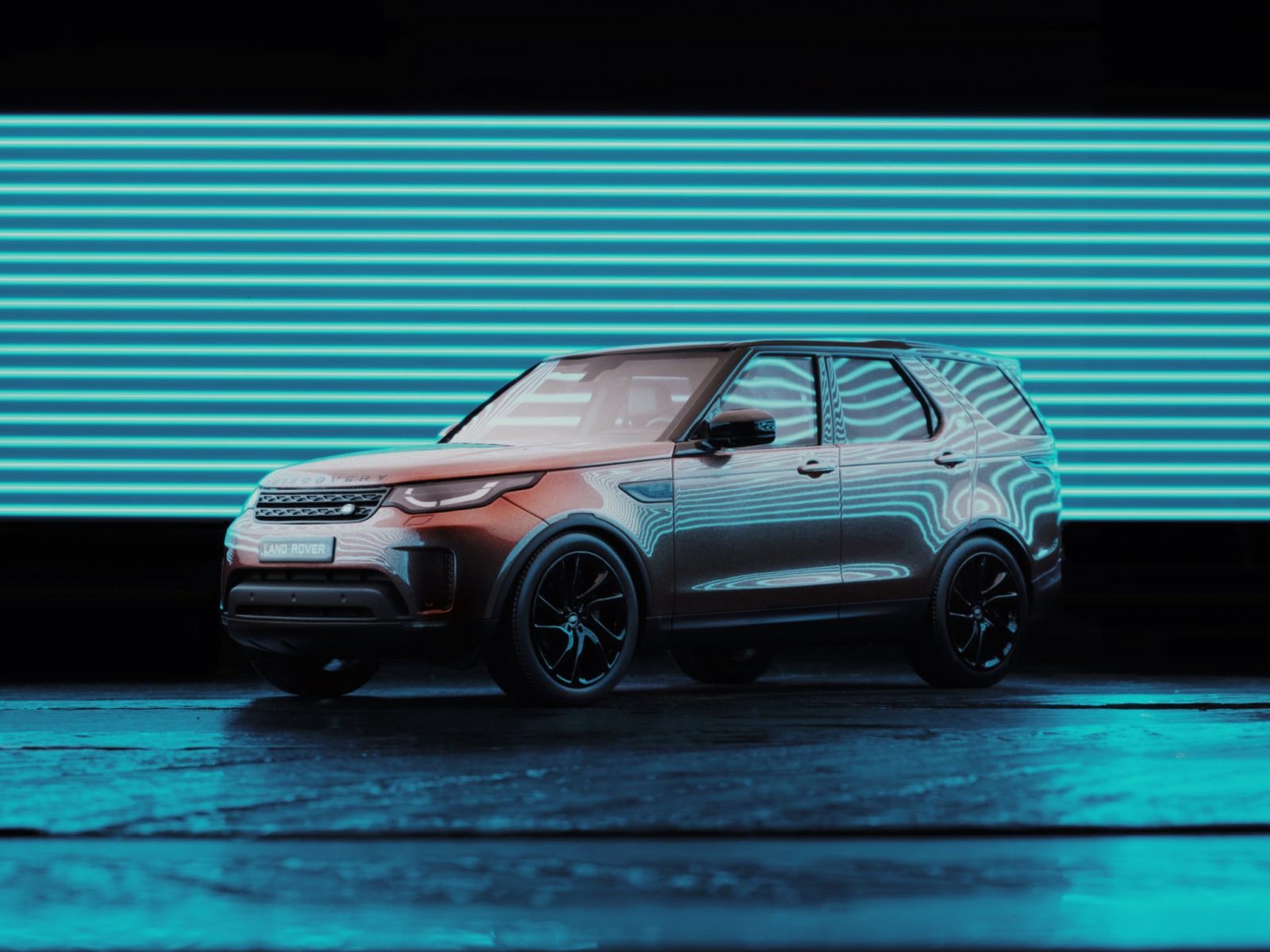 A Land Rover SUV parked in front of bright blue horizontal neon lights at night creates a striking scene of futuristic nighttime landscape photography.