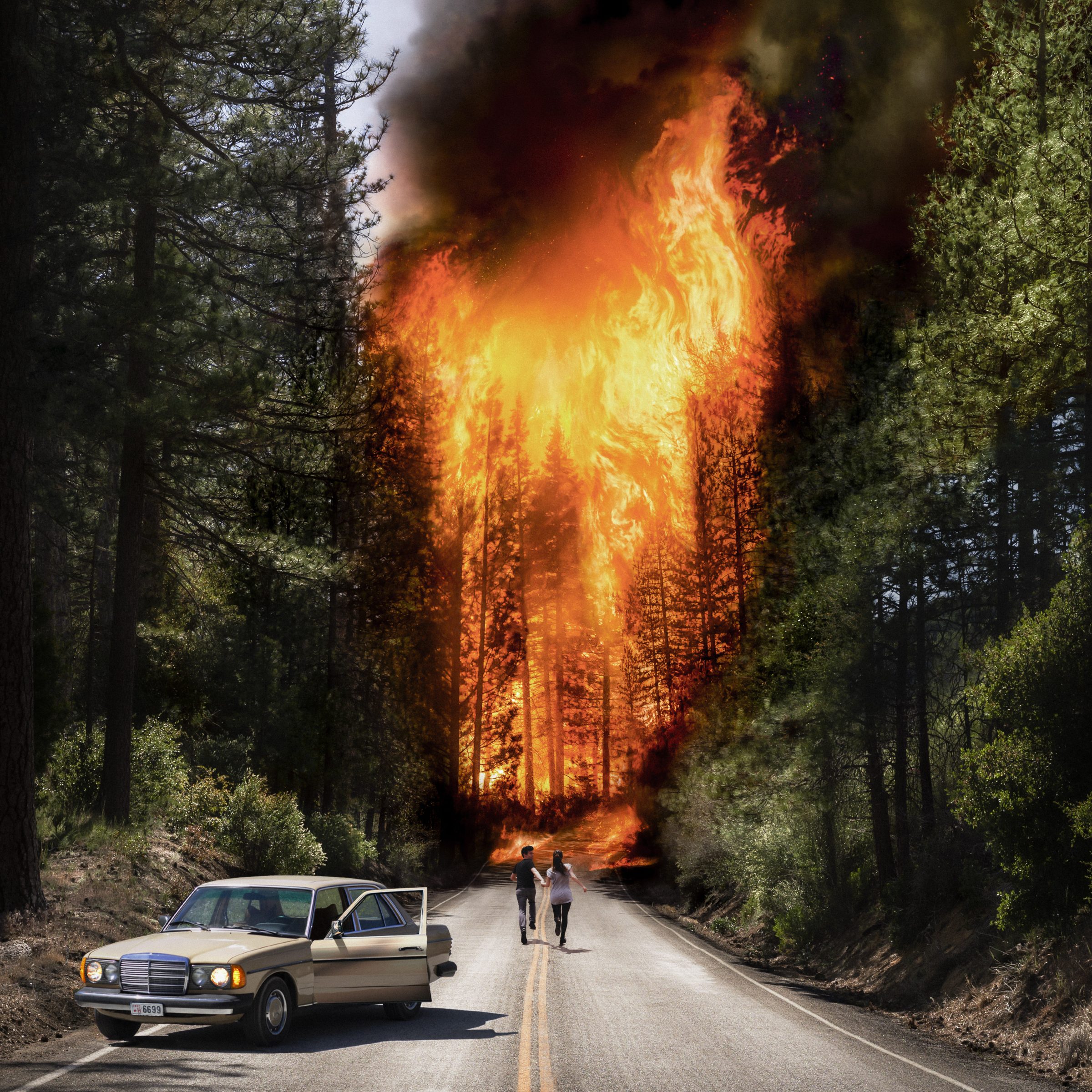 A couple walks toward a massive forest fire as smoke and flames engulf the trees beside an abandoned car, their path illuminated by futuristic drone light painting.